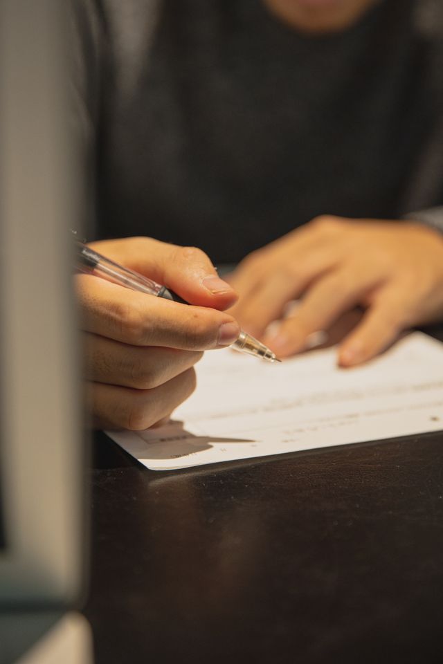 A hand writing something on paper